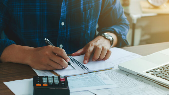 Man doing finances and calculate about cost to real estate inves
